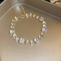 Close-up of gold-toned bracelet with sparkling emerald-cut clear zircons - 7# Gold Clear
