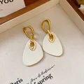 Elegant gold-finish earrings with white resin shield pendants for women in retro style - French Vintage Buckle Shield Style (99#) / Ear Buckle / Off White