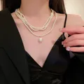 Elegant vintage multi-strand pearl necklace with a large round pearl pendant on a model - 13# Necklace-White