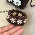 Artisanal brown and white wooden floral bead bracelet featuring a natural seed design - Coffee White Woven Style