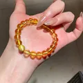 Dettaglio ravvicinato di un bracciale vintage in cristallo ambra con perla occhio di gatto - Stile 38 (WB419) / Giallo
