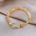 Macro di un bracciale in cristallo di pietra del sole dorata con ciondolo intagliato su raso - Bracciale 72# - Verde Chiaro - Elegante Confezione Regalo