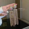 Luxurious long gold tassel drop earrings featuring iridescent pear-shaped crystals - Gold Tassel Style (13)