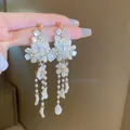 Elegant white floral drop earrings with pearl bead tassels and gold-tone finish - White Glass Flower Pearl Tassel Earrings