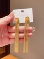 Detailed close-up of elegant gold metal tassel earrings with S925 silver needle posts. - Knot Fine Tassel Style / 9# Silver Pin - Gold