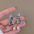Detailed view of elegant silver butterfly stud earrings with blue crystals and drop pearls - Butterfly Waterdrop Pearl Style (13#)