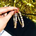 Elegant large gold-tone rhinestone hoop earrings with a sparkling geometric design - Oversized Rhinestone Hoop / Gold