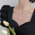 Double-layered elegant gold necklace featuring small pearls and a large baroque pearl pendant - Style 20 Necklace