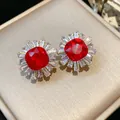 Macro view of vintage red gemstone earrings with sparkling baguette-cut zircon halo - Gold Base / Red