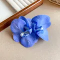 Close-up of blue fabric orchid hair clip with pearl detail for beach vacation style - Blue Flower (HH8269) / Blue