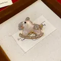 Macro view of an elegant enamel rocking horse brooch adorned with sparkling crystals - Rocking Horse (HP973) / White