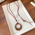 Retro Maillard style acrylic hollow round pendant necklace detail with brown suede cord. - Necklace-Coffee