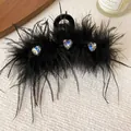 Close-up detail of a black feather hair claw clip with sparkling heart-shaped rhinestones - Hair Claw / Black