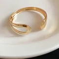 Detailed view of a gold-finish metal teardrop open cuff bracelet with glossy texture - Water Drop Shape / Gold