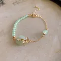 Elegant New Chinese style beaded bracelet featuring green beads and gold ginkgo leaf charm - Green Gold Style (53#)