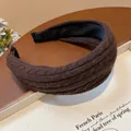 Close-up of brown knitted fabric headband with thick high cranial top design - Brown
