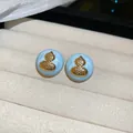 Detailed macro view of light blue enamel stud earrings featuring a golden gourd motif - Silver Needle / Gold-Blue