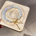 Elegant blue-tinted glass beaded bracelet with sparkling gold bow charm - Rhinestone Bow Style / White - Gold Bow (91#)