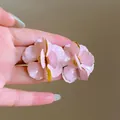 Close-up detail of elegant pink enamel flower earrings with gold trim and silver needles - Silver Needle / Pink