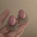 Hand holding pink oval and translucent grey square geometric resin stud earrings for women - Silver Needle / Pink