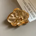 Elegant vintage gold orchid flower brooch with detailed metallic texture finish - Gold