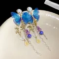 Detailed close-up of blue mesh butterfly earrings with elegant pearl tassels - Blue Mesh Butterfly Tassel Style / Gold