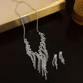Detailed view of shimmering rhinestone tassels on a geometric necklace and earrings set. - Necklace And Earrings (Square Tassel) / Silver