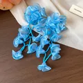 Close-up of elegant blue chiffon flower tassel earrings with delicate bead strings - Dark Blue