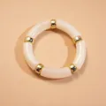 Elegant minimalist acrylic bamboo-style tube bracelet in cream with gold metal spacers - Bamboo Shape Acrylic Segment Bangle / Cream