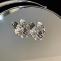 High-detail macro view of silver crumpled flower earrings with mirror reflection - Silver (Silver Pin)