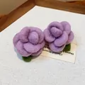 Close-up detail of handmade purple felt flower stud earrings with green leaves - Rose Style / Purple