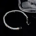Detailed close-up of a sparkling cubic zirconia tennis bracelet on a black reflective surface - Large Square Style (36#)