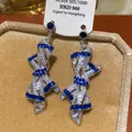 Detail view of luxurious ribbon-shaped earrings encrusted with blue and white crystals - Bowknot Long Drop / Silver Needle / 36# Silver Blue