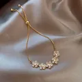 Elegant gold plated flower bracelet with sparkling zircons and adjustable pull chain - Star Petal Style (63#)