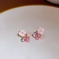 Detailed view of pink floral crystal stud earrings with resin flowers and gems - Gold-Pink-Flower Cluster