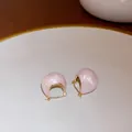 Macro detail of pink shimmering dome hoop earrings with elegant gold-toned metal finish - Gold Pink-Round Ball