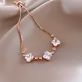 Rose gold adjustable bracelet with sparkling clover-shaped zirconia stones on satin - Clover Zirconia Style (126#)