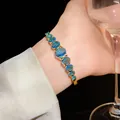 Luxurious gold-plated wrist bracelet featuring vibrant oval-shaped blue zircon stones - Gradient Oval Zirconia Style (129#)