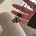 Detailed macro view showing a natural tiger eye teardrop pendant necklace held by a hand - 2# Necklace-Silver Mottled