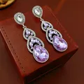 Elegant vintage court style dangle earrings with pear-cut purple crystals. - Style 66