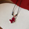Close-up of red flocked rocking horse necklace with zircon and colorful beads details. - 1# Necklace-Black Beaded Rope / Red