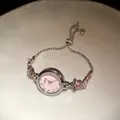 Close-up of elegant silver star bracelet watch with pink dial and rhinestone accents - Star Bracelet Watch / Silver-Pink