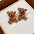 Close-up detail of cute brown flocked teddy bear stud earrings with red accents. - Coffee (2#)