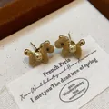 Close-up of brown flocked teddy bear stud earrings with gold accents on jewelry box - Coffee (11#)