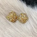 Elegant rhombus gold-tone stud earrings with intricate white zircon inlay details - Stud and Clip Style / Gold