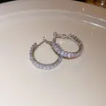 Detailed view of silver hoop earrings featuring sparkling baguette cut clear crystals - Rhinestone Hoop Style