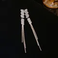 Detail of silver long tassel drop earrings with rectangular clear rhinestones - Trapezoid Chain Tassel Style