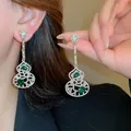 Elegante holle kalebas oorbellen met smaragdgroene edelstenen en schitterende strassteentjes - Kalebas Vorm Zilveren Stift Stijl / Zilver-Groen