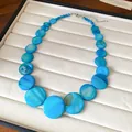 Detail view of Bohemian blue iridescent shell disc necklace for beach vacation. - Blue
