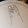 Elegant long dangling star earrings with sparkling rhinestones in a refined silver finish - Star Tassel Style